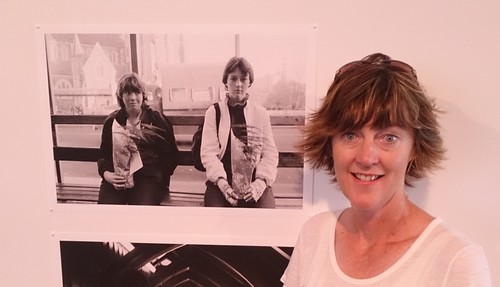 Caption: Megan from Rangiora with a photograph of her (seated right) and her friend at the Cathedral Sqaure bus stop taken in 1984.