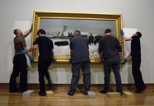 Petrus van der Velden's The Dutch funeral (1875) being hung for display