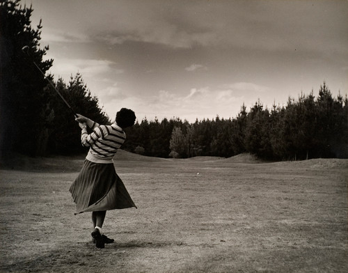 Rudolf Gopas Hawkes Bay Ladies Champion Hitting Off First Hole at Waimairi Beach Golf Course. Black and white photograph. Collection of Christchurch Art Gallery Te Puna o Waiwhetū, presented to the Gallery by Airini Gopas 1986. Reproduced with permission