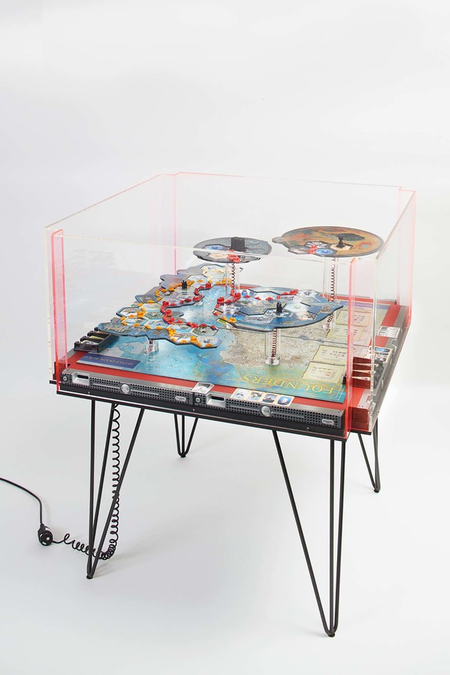 Simon Denny Founders Board Game Display Prototype / Founders Rules 2017. Customised Settlers of Catan game pieces, 3D print, UV print on Butler Finish Aluminium Dibond, UV print on card, LEDs, moulded electronic wiring, Dell PowerEdge 1950 server casing, Linoleum, MDF, powder coated steel, Pexiglas / UV prints on canvas. Auckland Art Gallery Toi o Tāmaki, purchased 2018