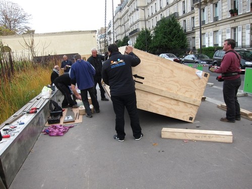 The crane driver (on the right) lowering the crates into position.