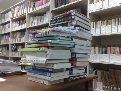 Pile of books in Robert and Barbara Stewart Library, Christchurch Art Gallery Te Puna o Waiwhetū