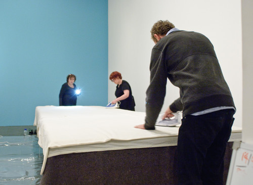Members of the conservation and installation teams from the Gallery and the National Gallery of Victoria preparing In bed for display.