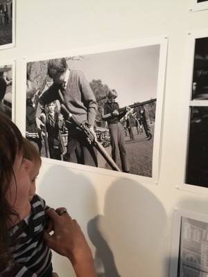 Caroline's sister Katherine with nephew Ari looking at the photograph in which their father appear in the background.