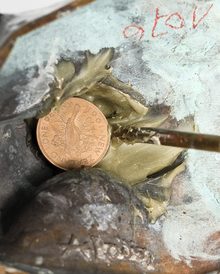 The underside of Eternal Idol, showing the penny sealed in place.