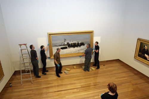 Petrus van der Velden's The Dutch funeral (1875) being hung for display