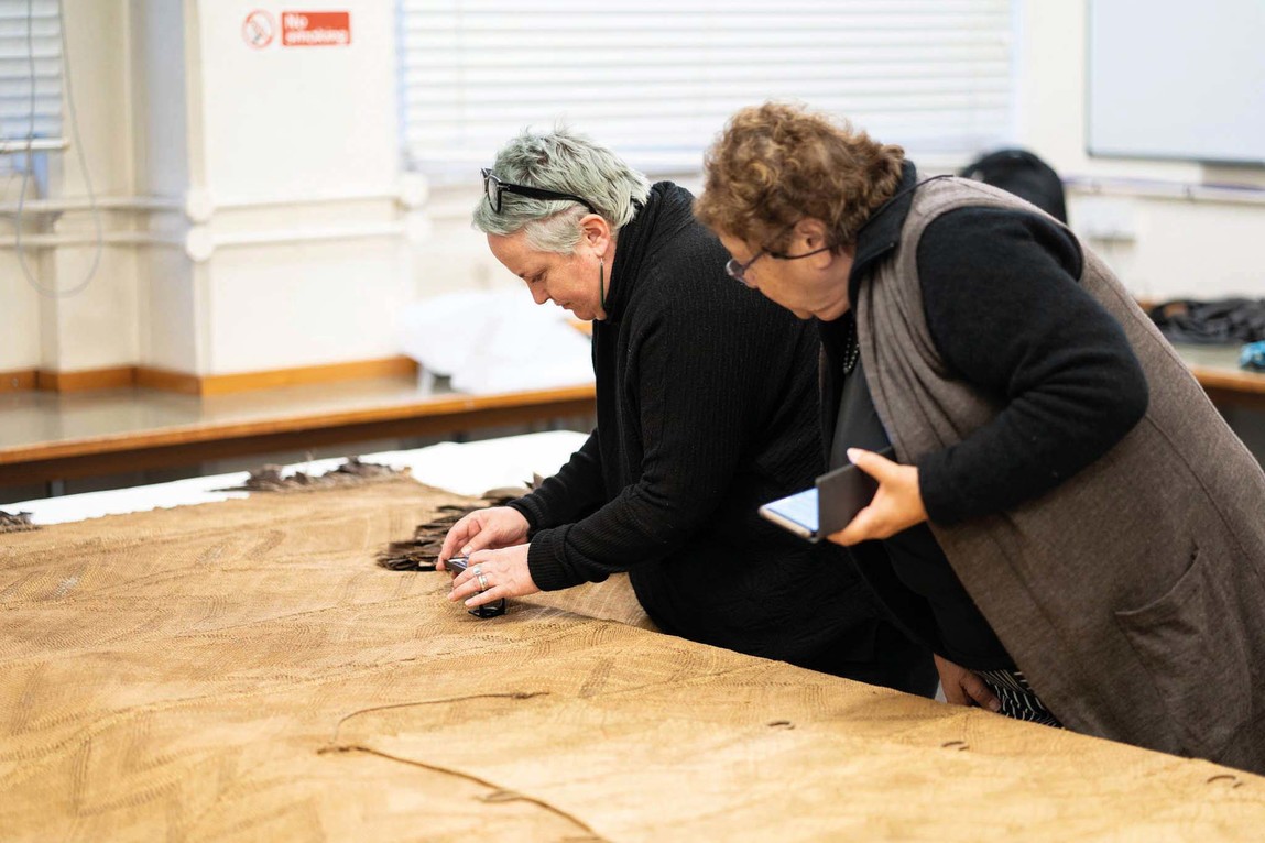 Catherine Smith and Ranui Ngarimu inspecting Te Rā at the British Museum. © The Whakaarahia anō te rā kaihau Te Rā Project. Photo: Adam Rowley