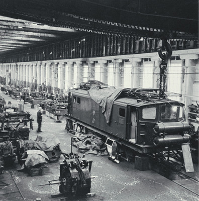 Christchurch to Lyttelton suburban Ec electric locomotive undergoing maintenance in the Addington Workshops, [ca. 1960]. Collection of Christchurch City Libraries.